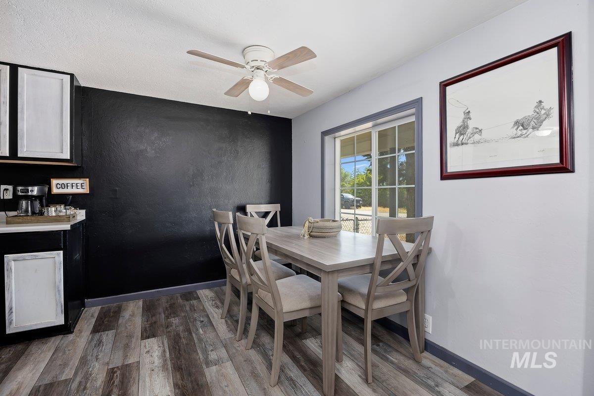 418 South Date Street Shoshone, ID 83352 - Photo 9 of 36 Dining area featuring wood-finish flooring and a ceiling fan with integrated lighting