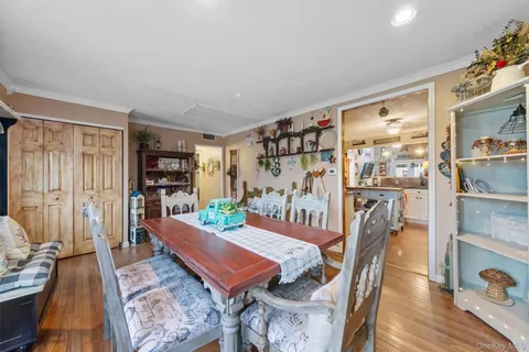 a dining room with furniture and wooden floor