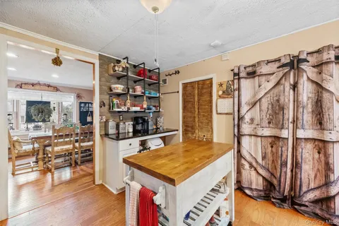 a kitchen that has a lot of cabinets in it and wooden floor