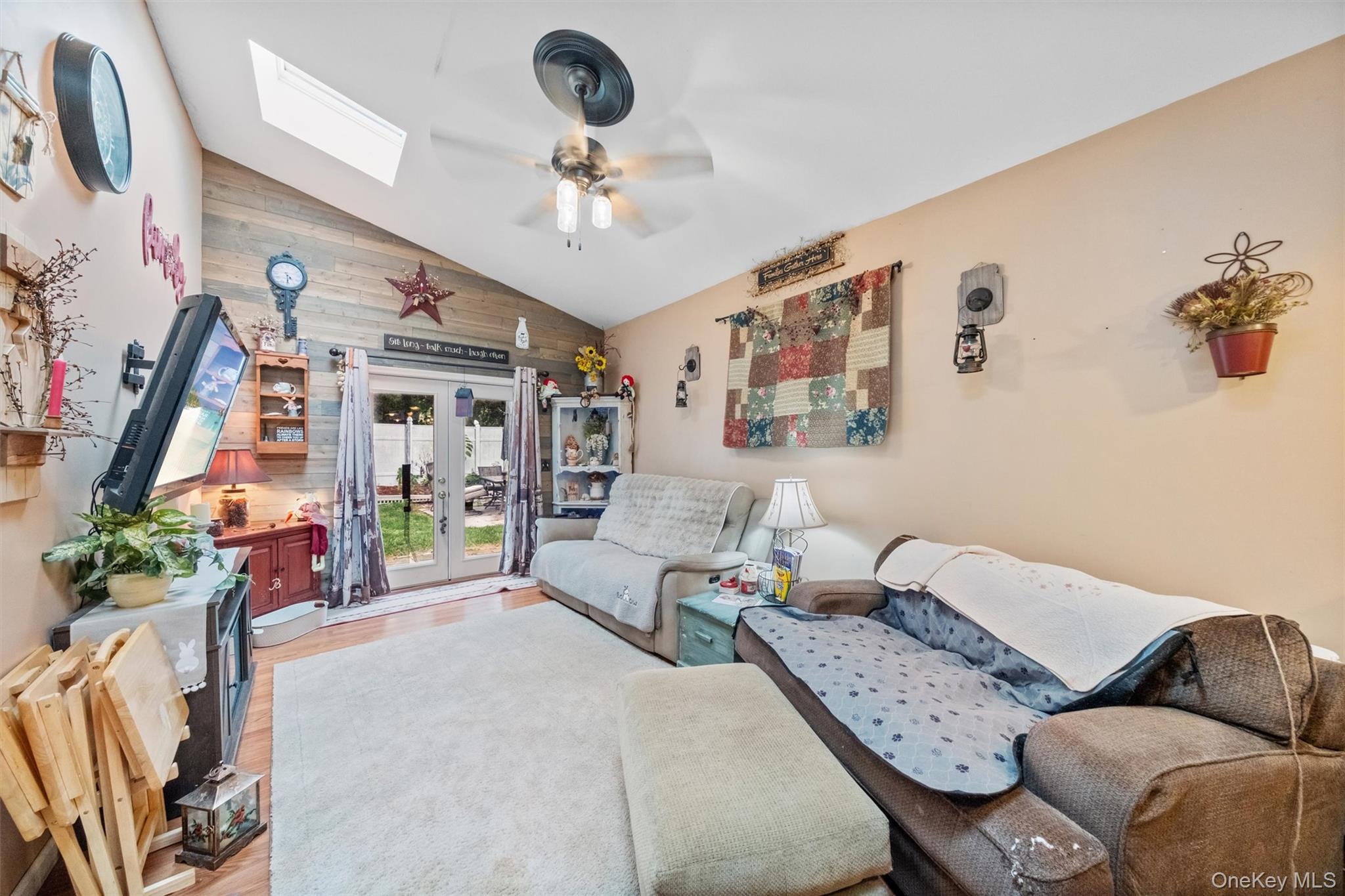 17 Perry Road Cornwall, NY 12518 - Photo 20 of 38 Living room featuring lofted ceiling, a skylight, wood finished floors, french doors, and a ceiling fan
