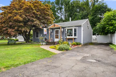 a front view of house with yard and green space