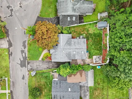 an aerial view of a house with a yard and garden