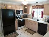 8 Weather Deck Road Bourne, MA 02532 - Photo 4 of 17 a kitchen with a sink stove and refrigerator