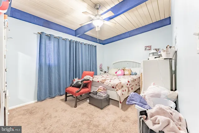 a bedroom with a bed and a fan