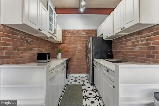 a kitchen with stainless steel appliances a stove a sink and a refrigerator