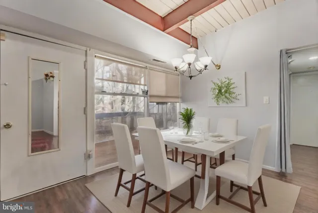 a dining room with furniture and chandelier