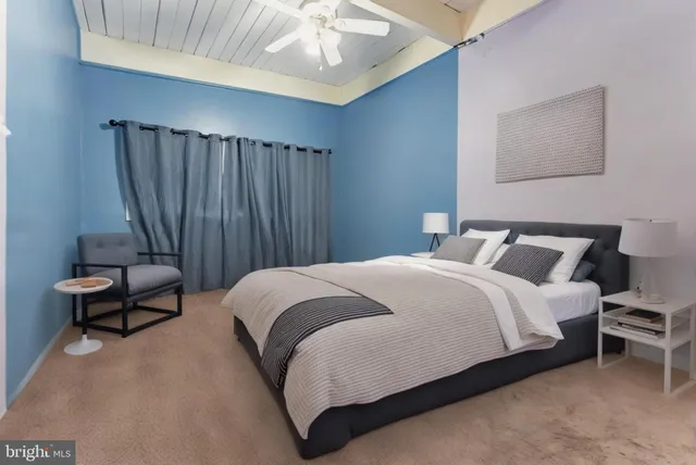 a bedroom with bed and chair