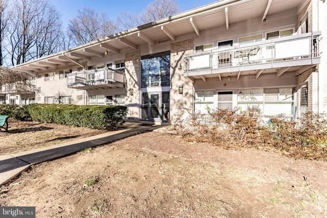 a view of a yard with wooden fence