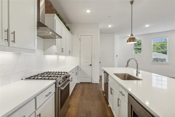 a kitchen with a sink stove and cabinets