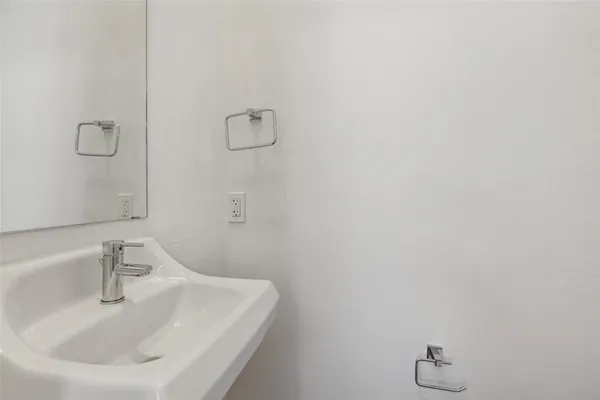 a bathroom with a sink and mirror