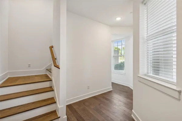 a view of entryway with wooden floor and white walls