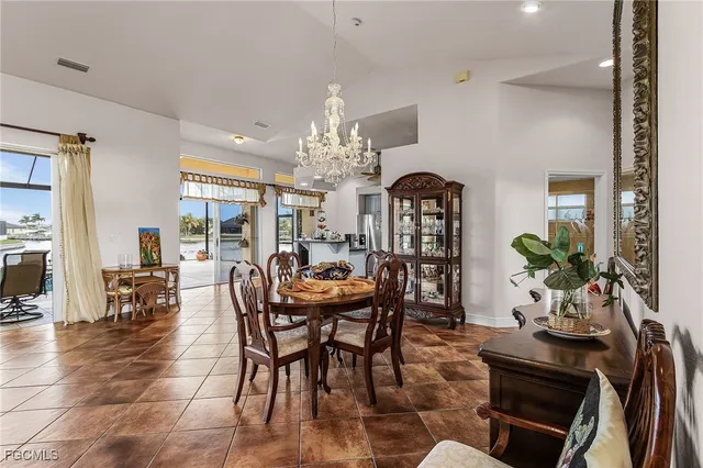 a view of a dining room with furniture and chandelier