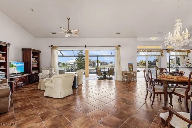 a living room with couches and a dining table with kitchen view