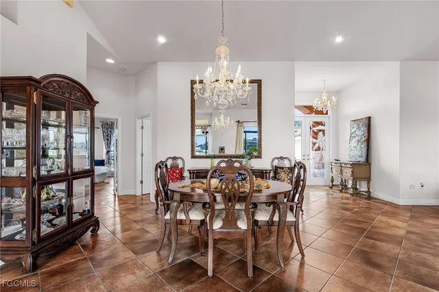 a view of a dining room with furniture and a chandelier
