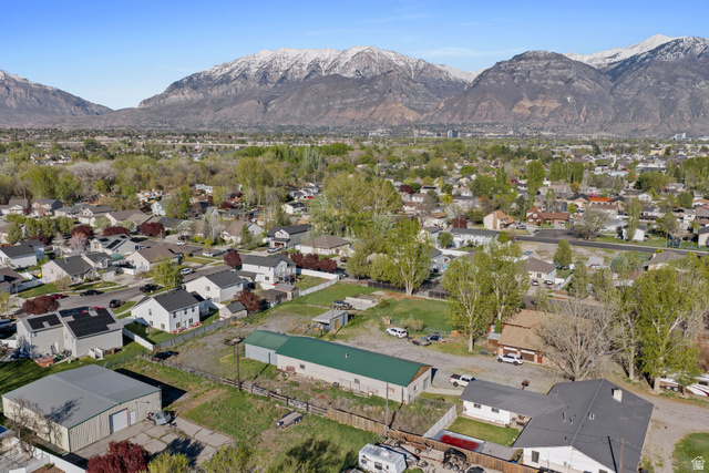 49 North 2830th West, Unit 3 Provo, UT 84601 - Photo 10 of 13 Aerial view of property and surrounding area featuring a mountainous background and nearby suburban area