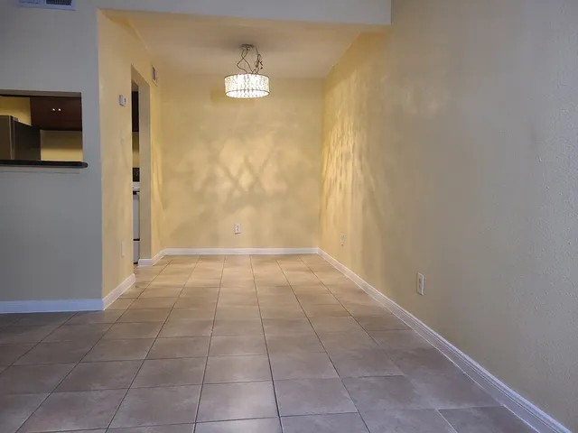 a view of a livingroom with wooden floor and a bathroom