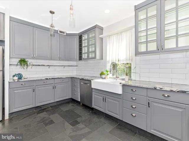 a bathroom with a double vanity sink toilet and shower