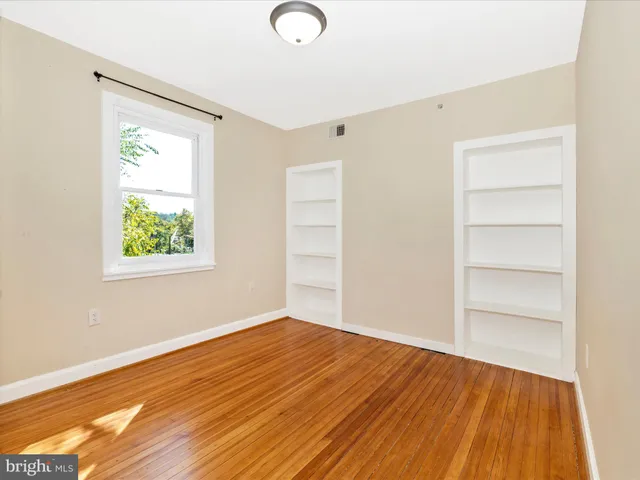 a view of an entryway with wooden floor