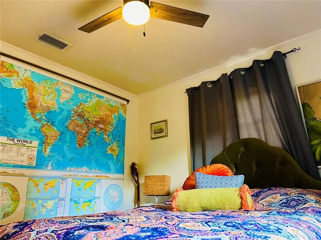 a bedroom with a bed and a painting on the wall