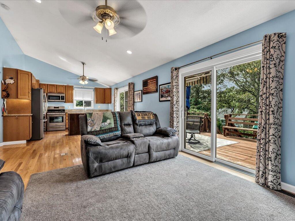 62 Deer Ridge Road Mashpee, MA 02649 - Photo 21 of 40 a living room with furniture a fireplace and a chandelier