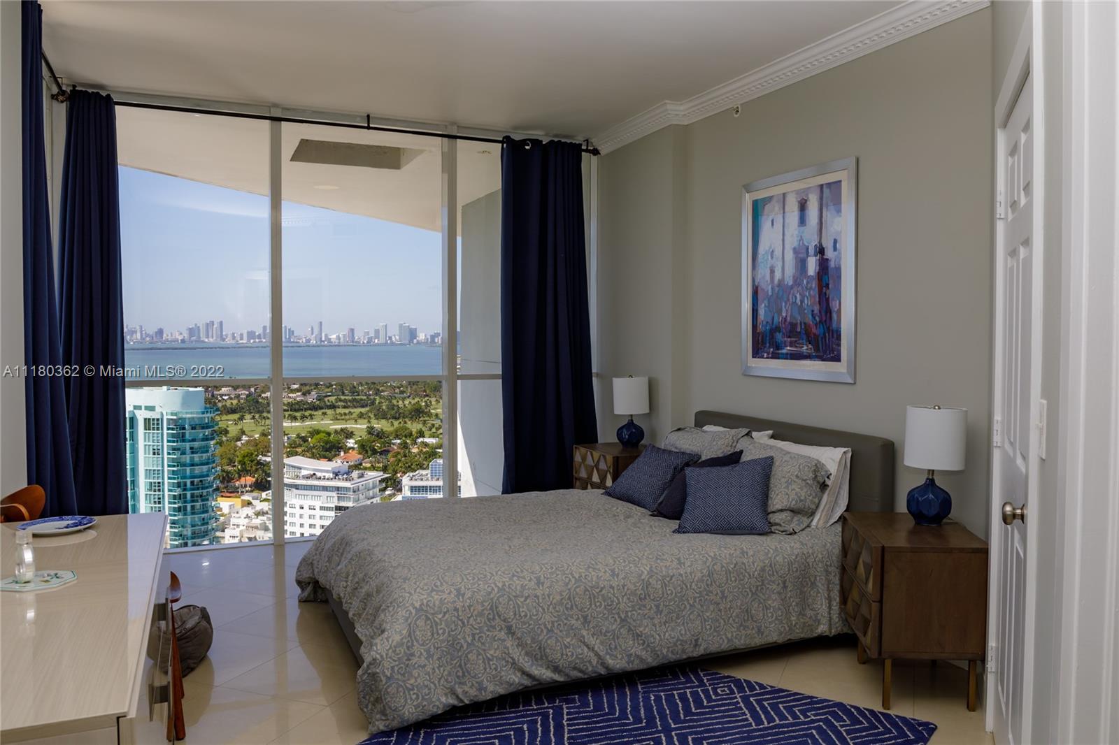 6301 Collins Avenue, Unit PH4 Miami Beach, FL 33141 - Photo 12 of 18 a bedroom with a large bed and a window