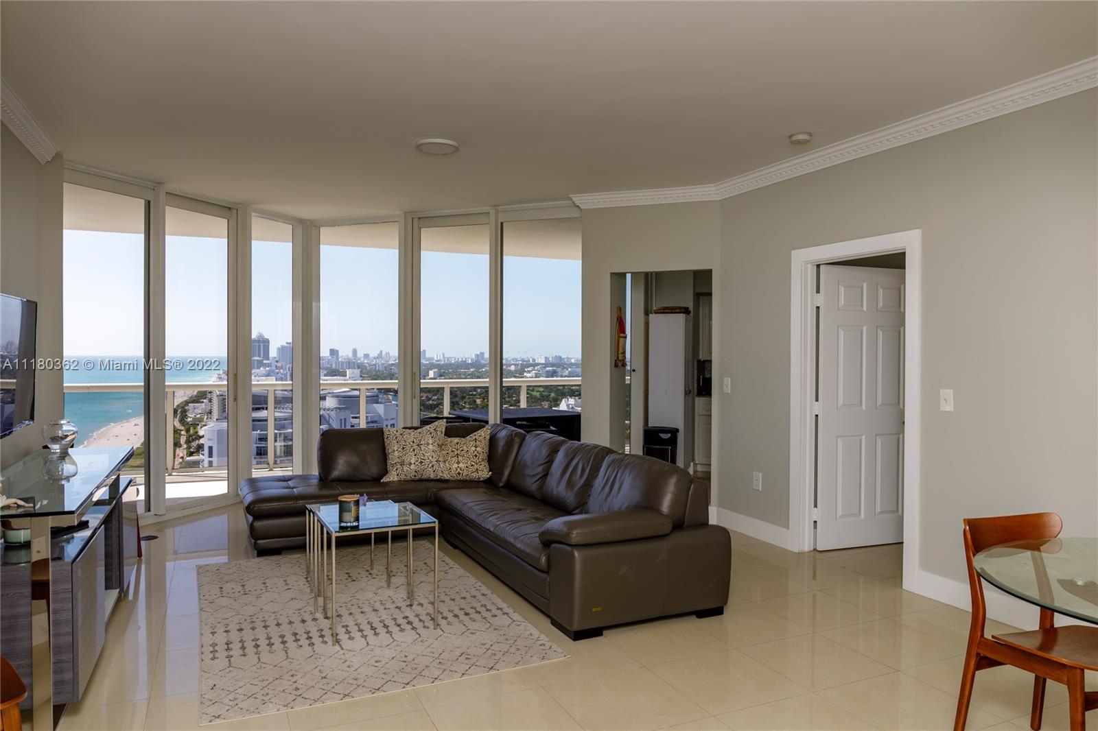 6301 Collins Avenue, Unit PH4 Miami Beach, FL 33141 - Photo 2 of 18 a living room with furniture and a large window