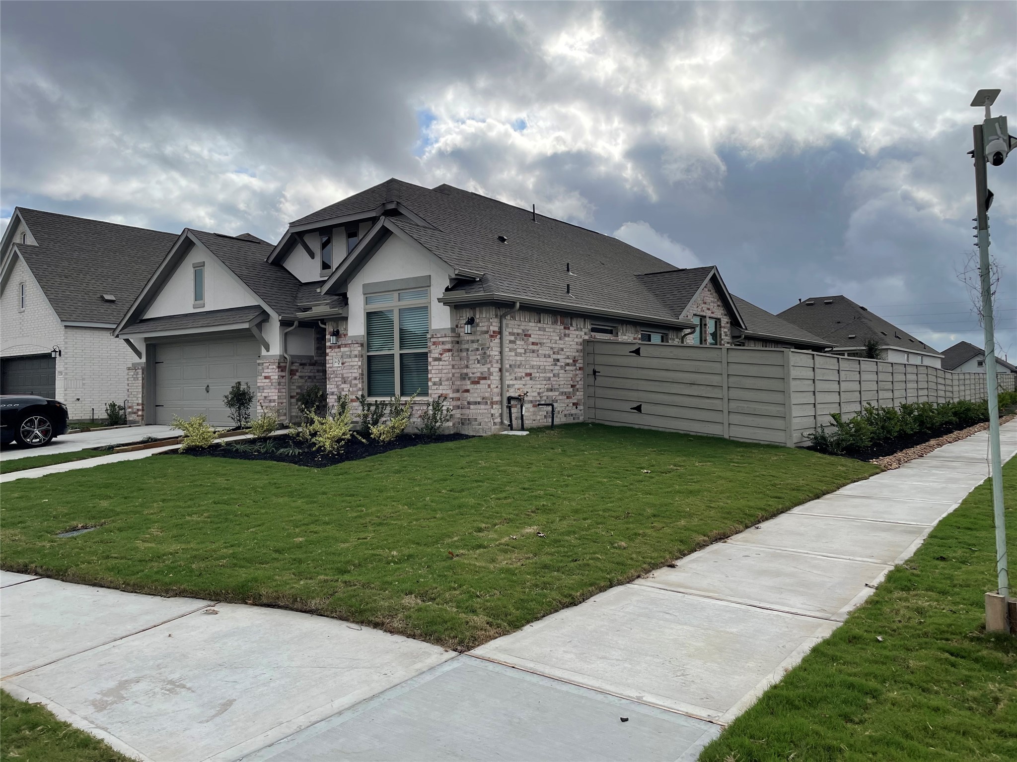 2302 Hazel Berry Street Manvel, TX 77578 - Photo 1 of 27 a front view of a house with a garden