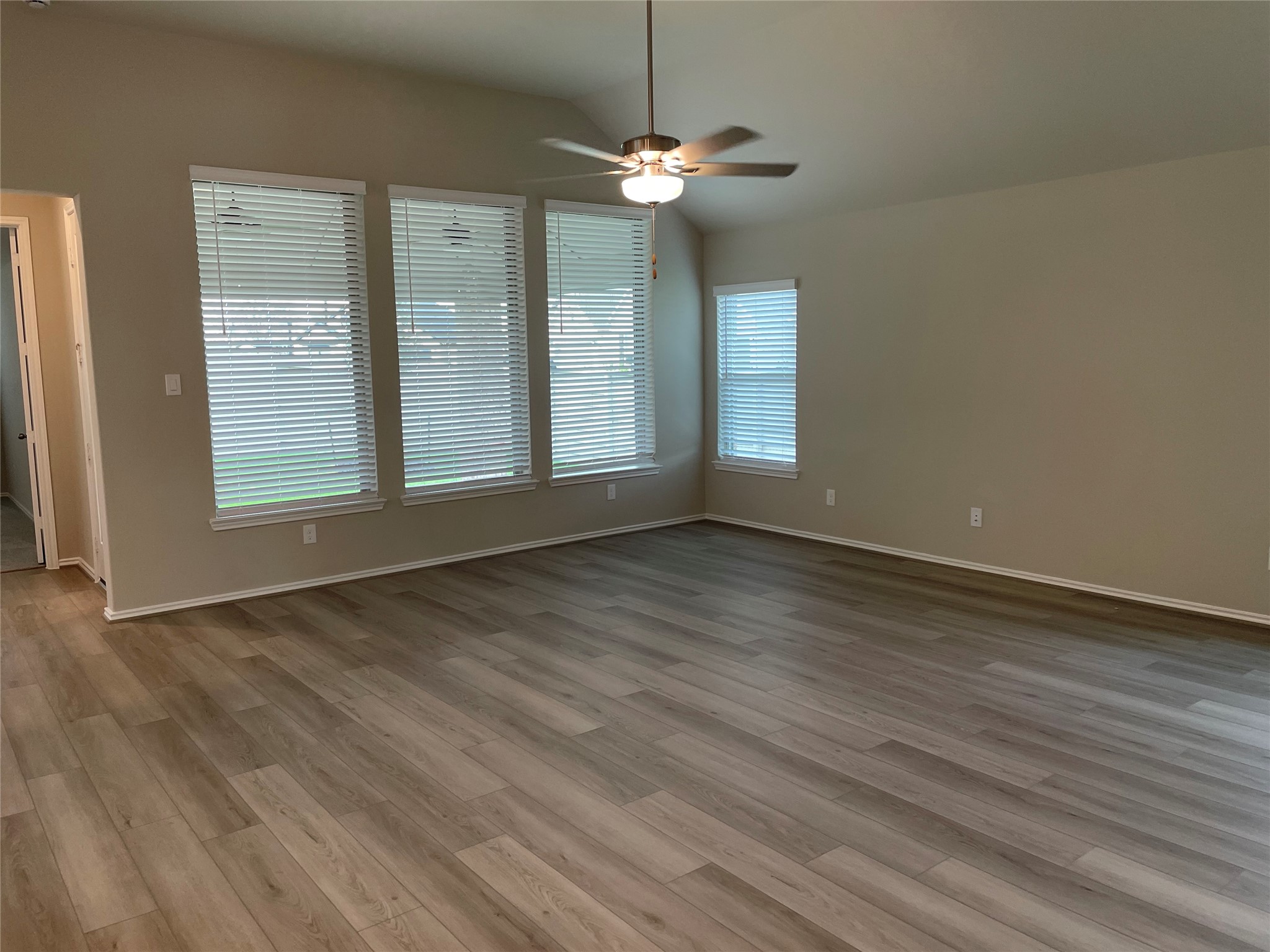 2302 Hazel Berry Street Manvel, TX 77578 - Photo 19 of 27 a view of an empty room with wooden floor and a window