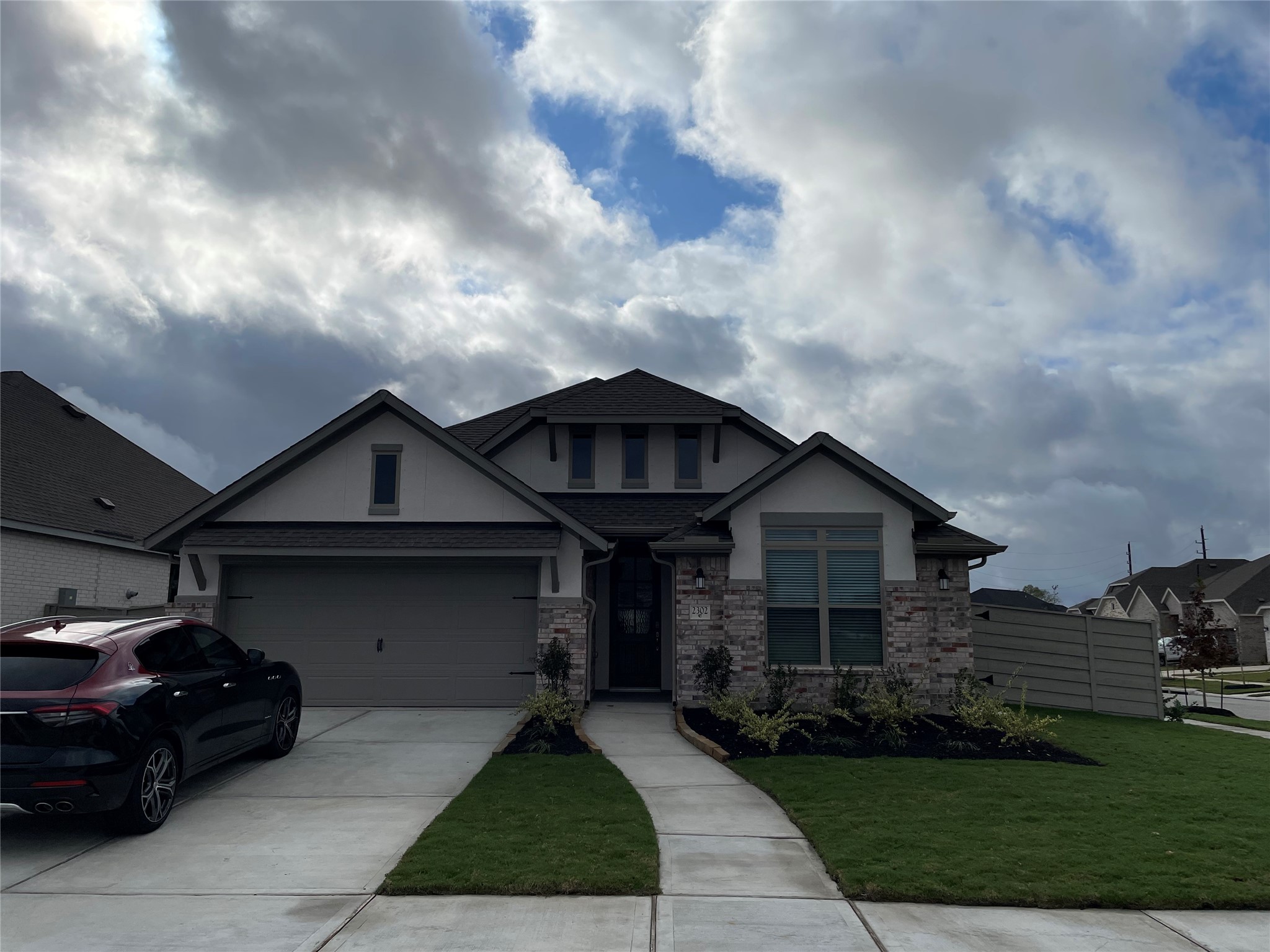 2302 Hazel Berry Street Manvel, TX 77578 - Photo 2 of 27 a front view of a house with a garden and pathway