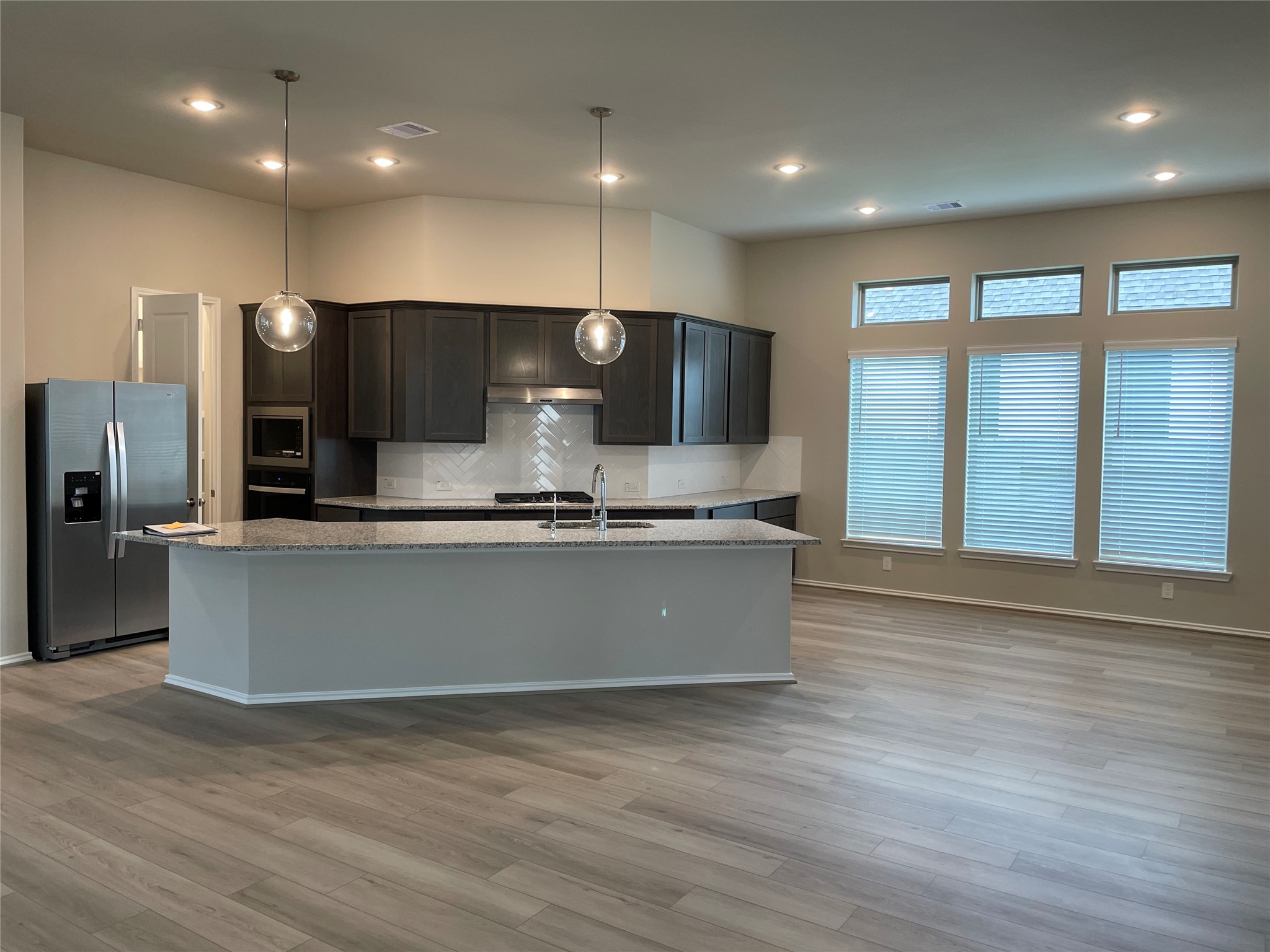 2302 Hazel Berry Street Manvel, TX 77578 - Photo 21 of 27 a view of kitchen with stainless steel appliances wooden floor and large window