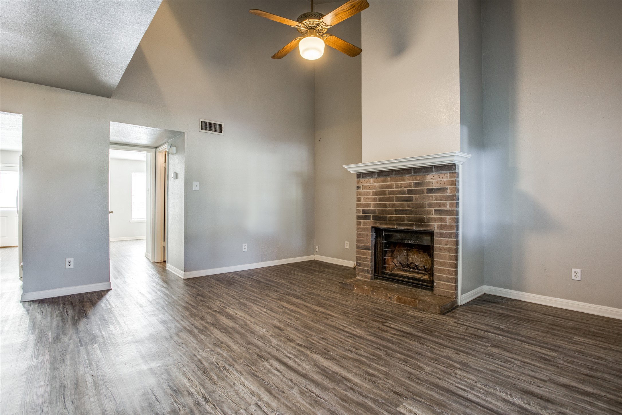 106 Verna Spur, Unit B Georgetown, TX 78628 - Photo 4 of 25 A striking brick fireplace provides a warm focal point in this expansive living area.