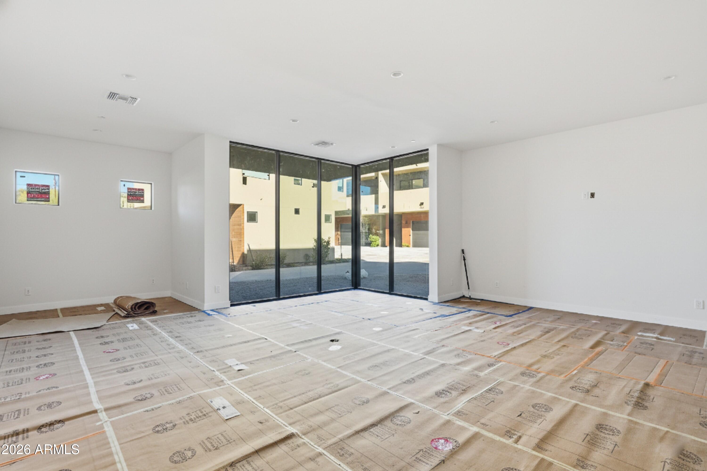 6525 East Cave Creek Road, Unit 105 Cave Creek, AZ 85331 - Photo 3 of 14 a large white bed in a bedroom next to a window