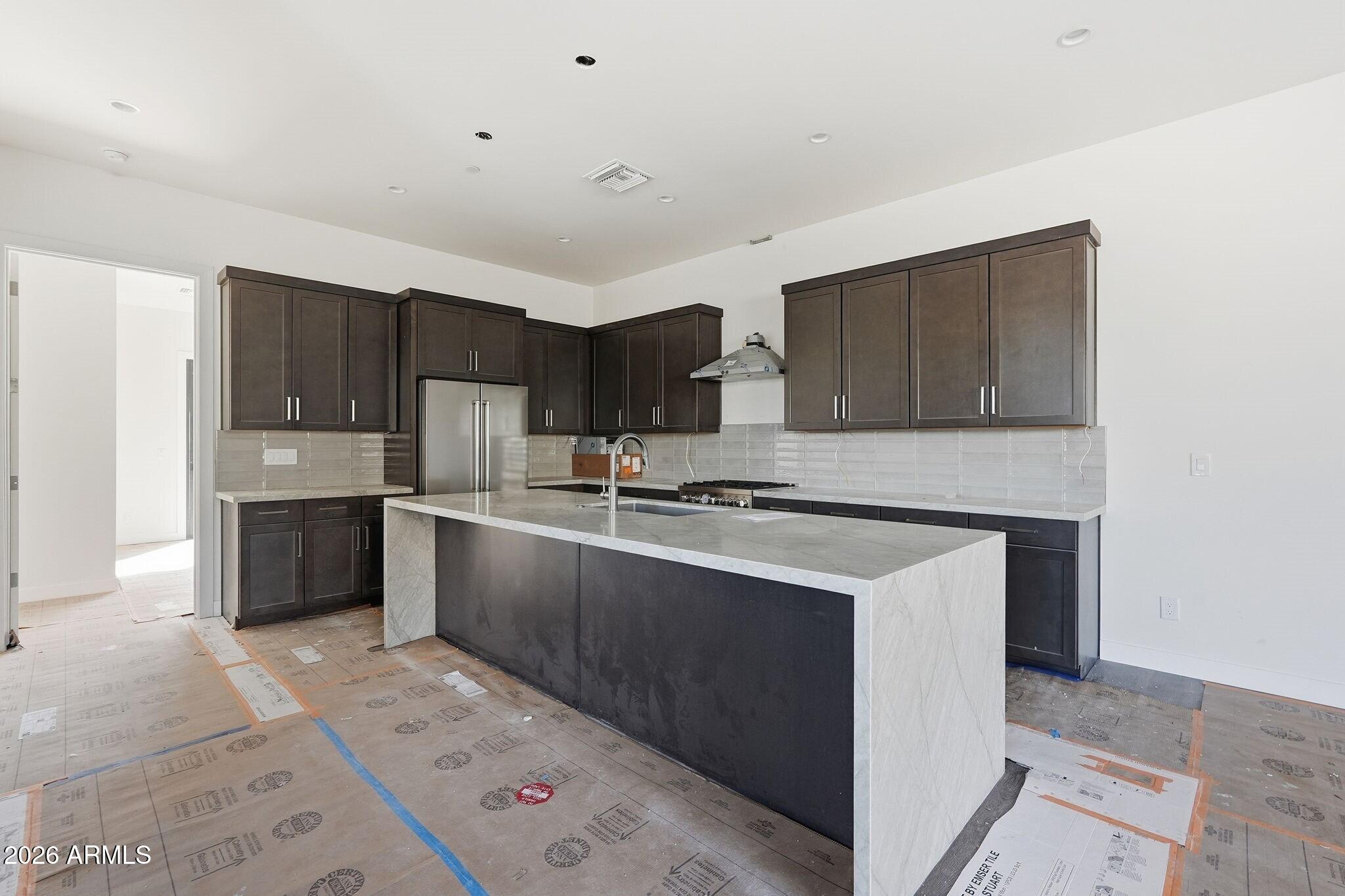 6525 East Cave Creek Road, Unit 105 Cave Creek, AZ 85331 - Photo 6 of 14 a kitchen with stainless steel appliances granite countertop a stove a sink and a refrigerator