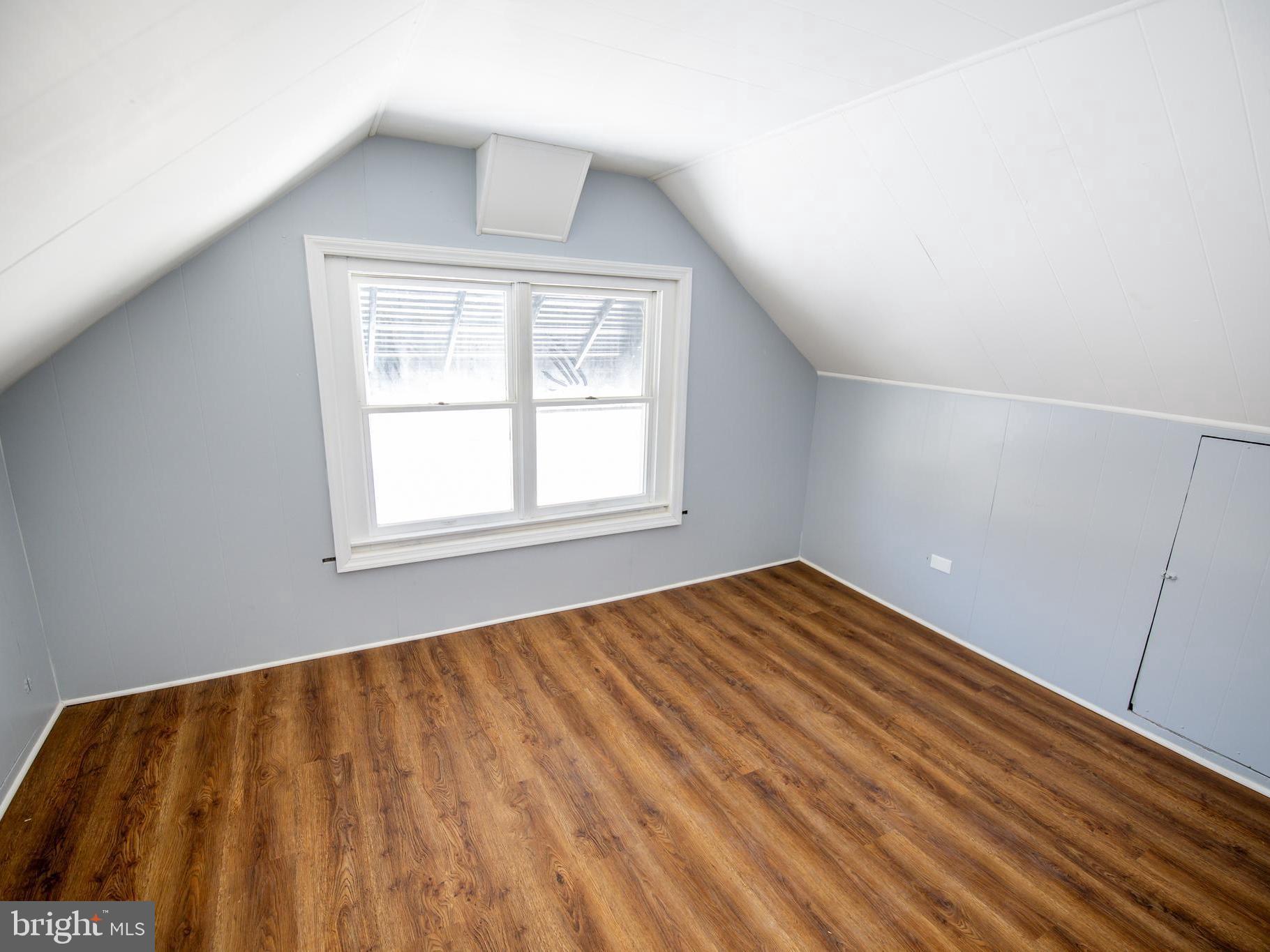 2605 Ambler Road Baltimore, MD 21222 - Photo 13 of 25 a view of an empty room with wooden floor and a window