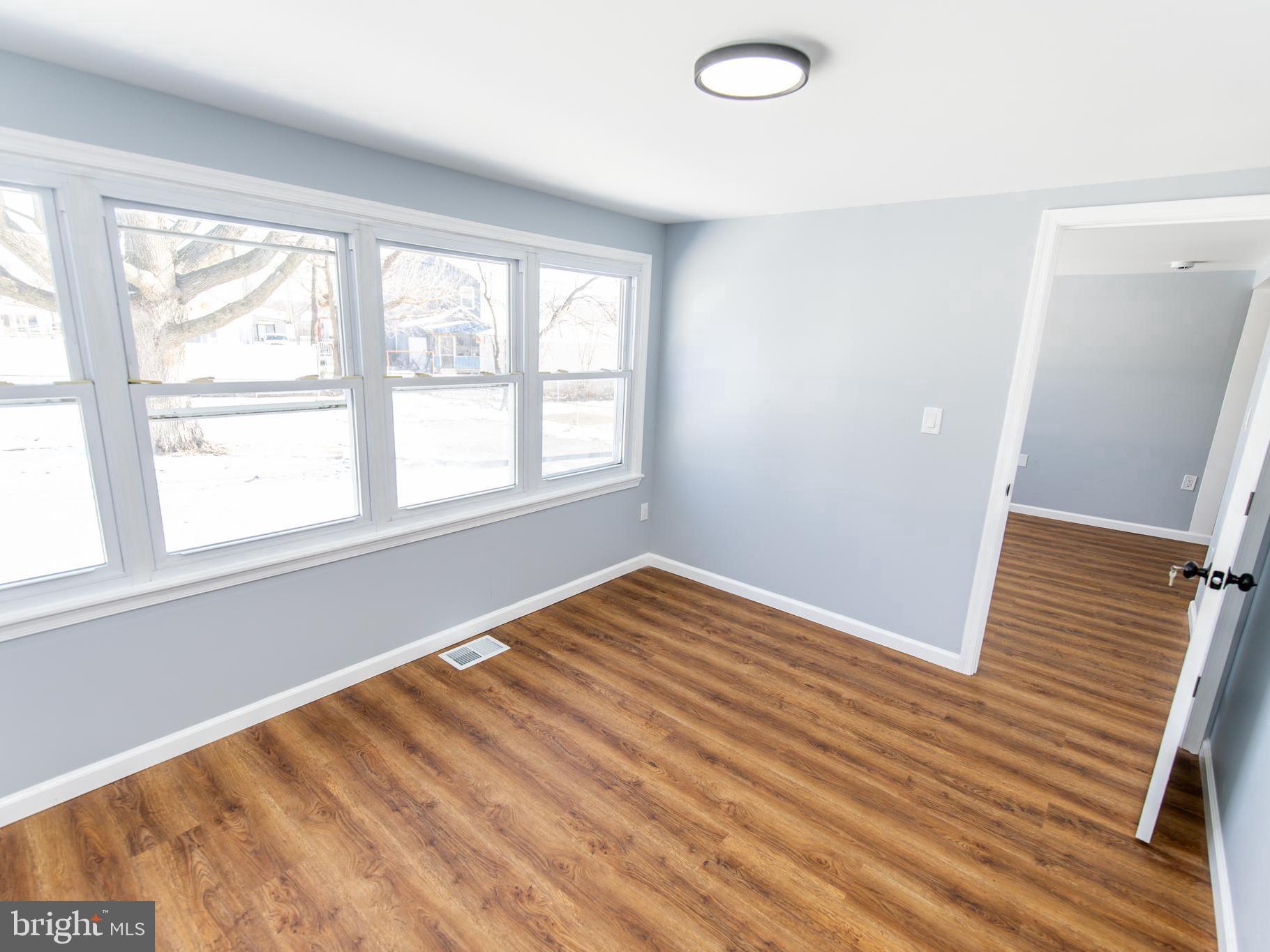 2605 Ambler Road Baltimore, MD 21222 - Photo 15 of 25 a view of an empty room with wooden floor and a window
