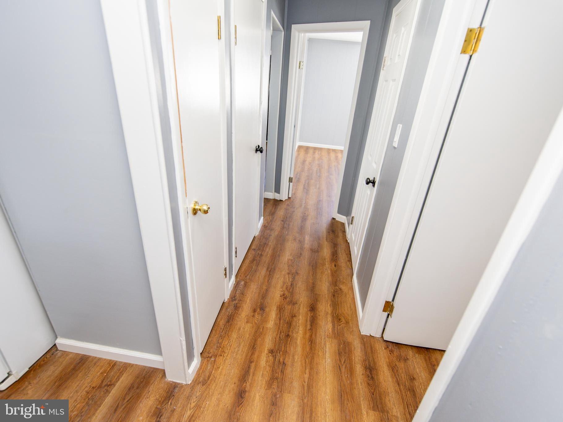 2605 Ambler Road Baltimore, MD 21222 - Photo 16 of 25 a view of a hallway with wooden floor and staircase