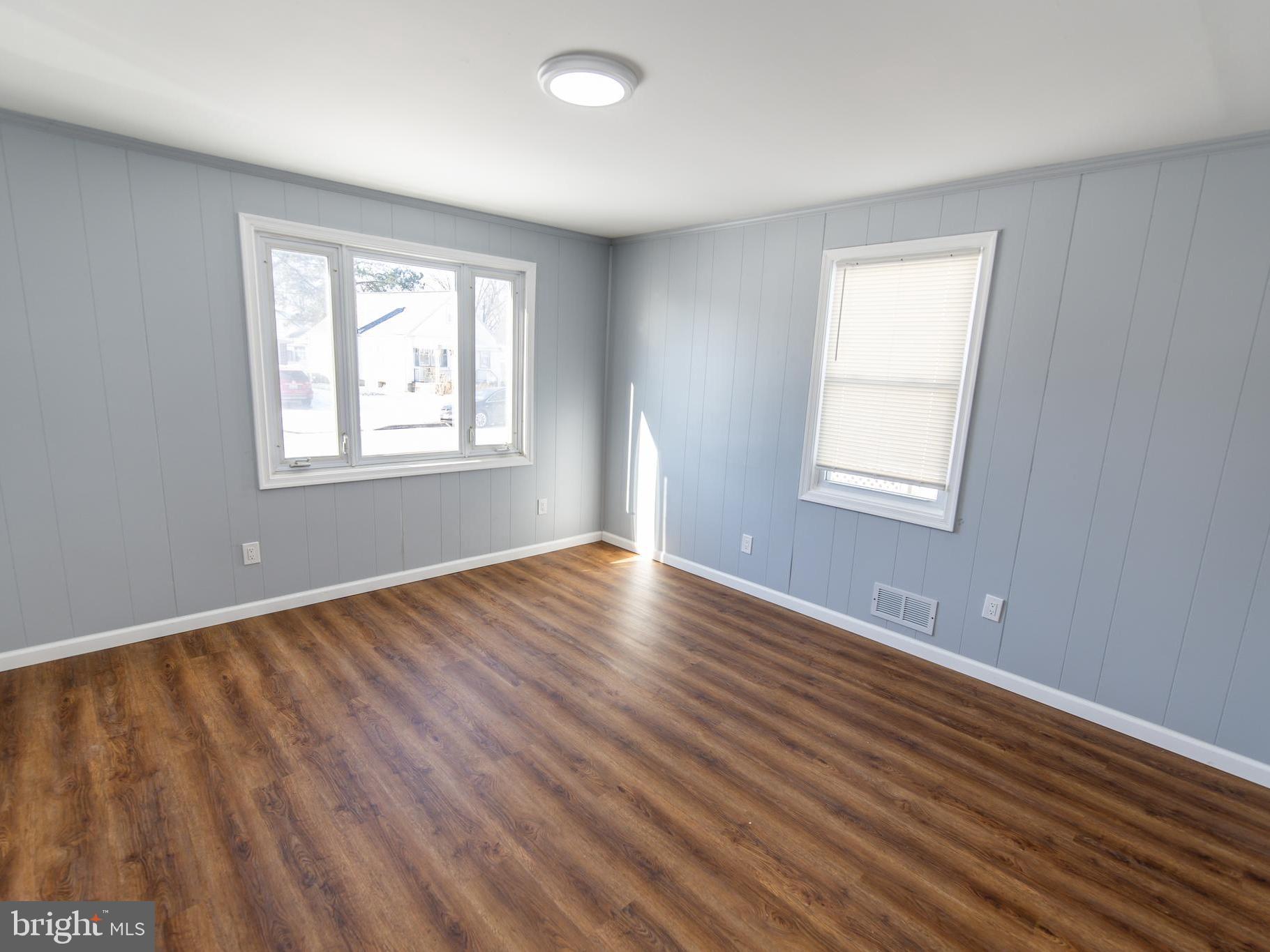2605 Ambler Road Baltimore, MD 21222 - Photo 17 of 25 a view of an empty room with wooden floor and a window