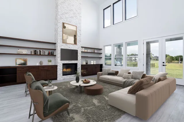 a living room with furniture potted plant a fireplace and a large window