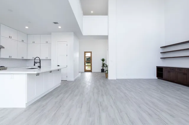 a view of a kitchen with wooden floor and electronic appliances