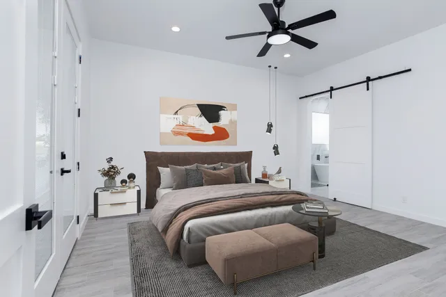 a bedroom with a bed and a chandelier