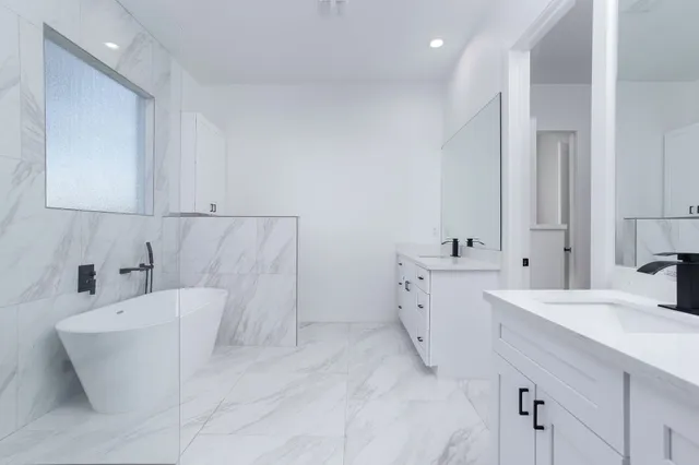 a bathroom with a bathtub sink and mirror