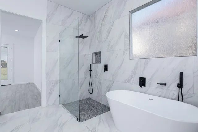 a bathroom with a bathtub and shower