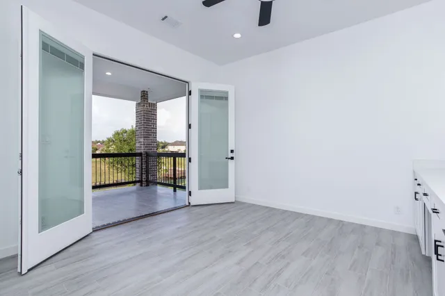 wooden floor in an empty room with a floor to ceiling window