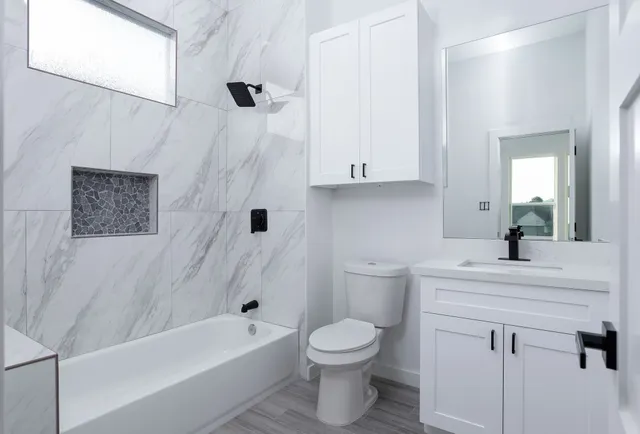 a bathroom with a sink a toilet and a bathtub