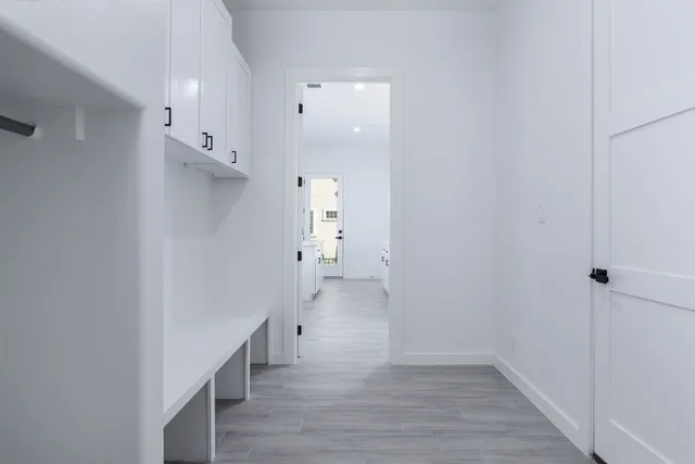 a view of a hallway with wooden floor