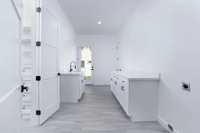 a utility room with cabinets washer and dryer