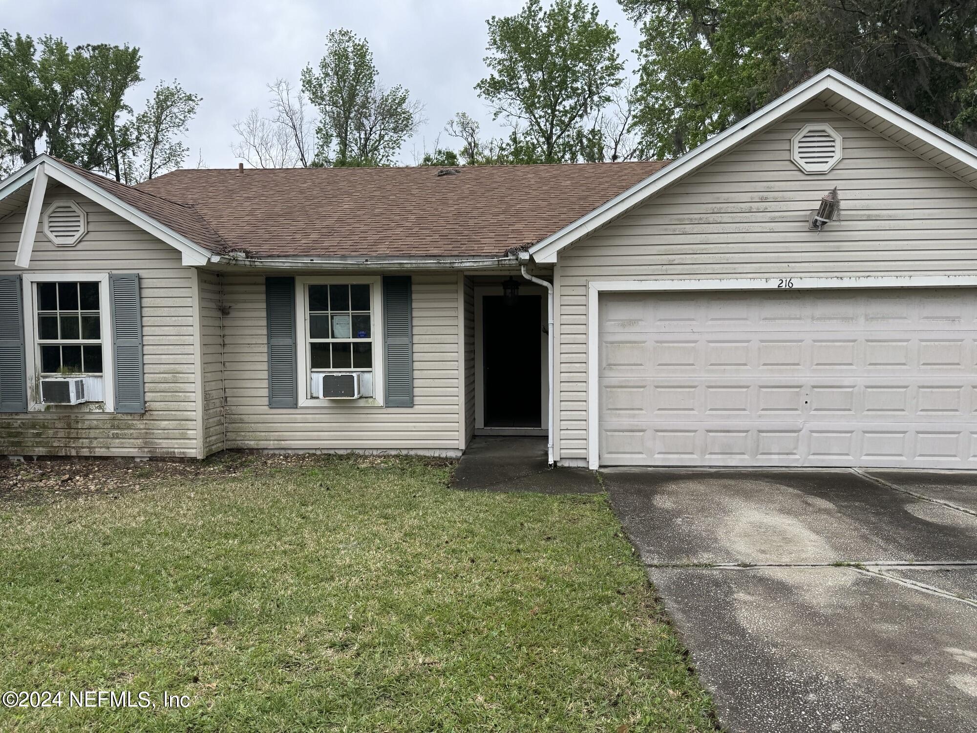 a view of a house with a yard