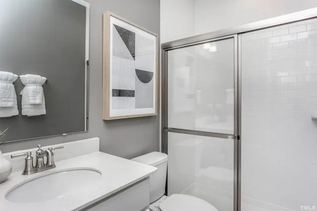 a bathroom with a sink toilet and shower