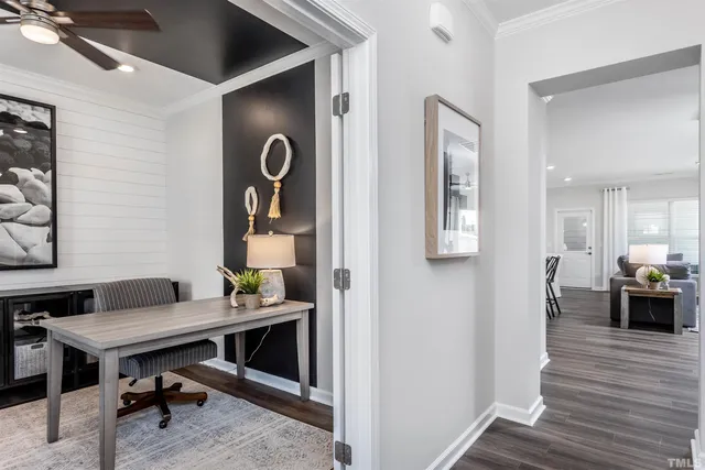 a view of a workspace with furniture and wooden floor