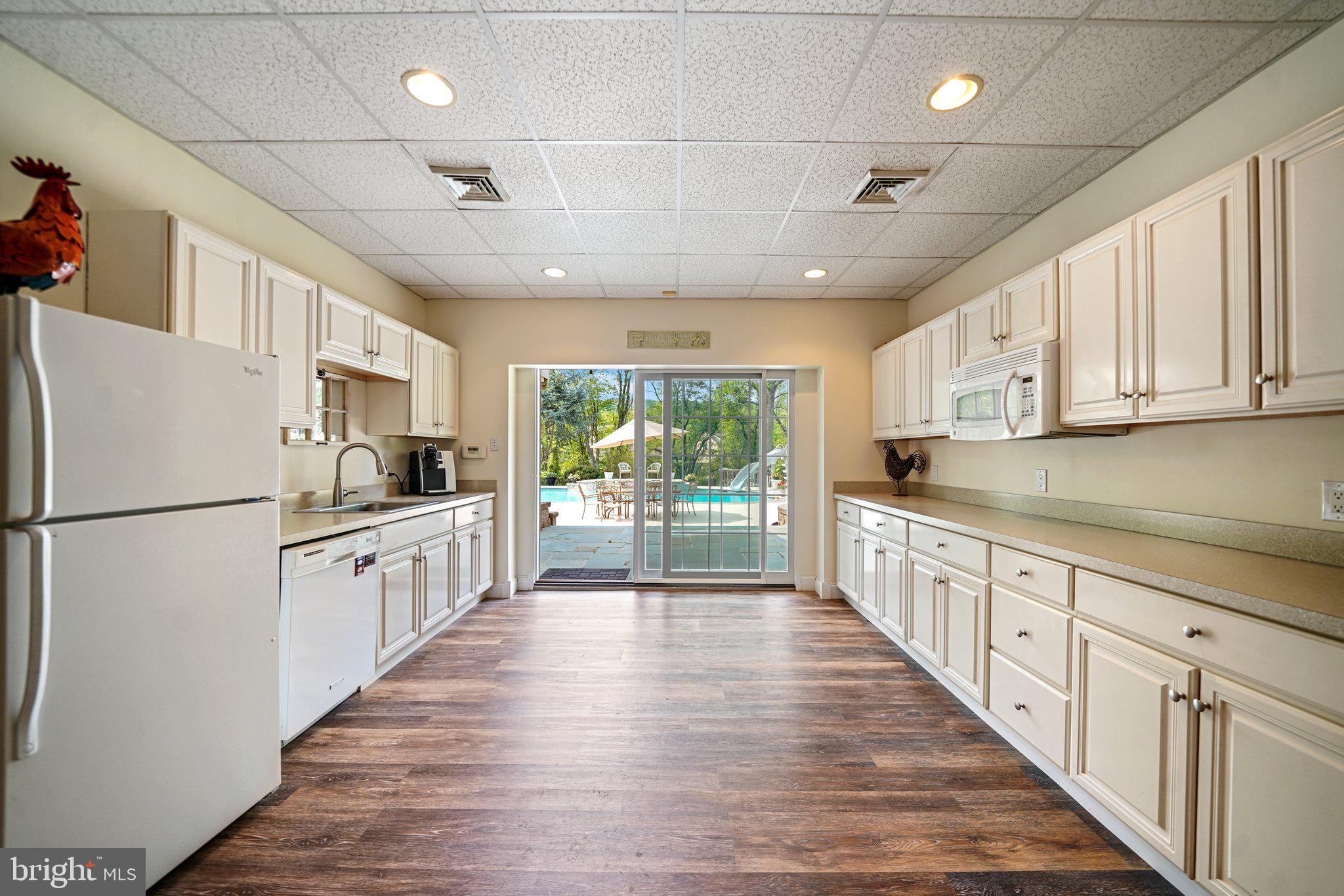 14 Clover Mill Lane Malvern, PA 19355 - Photo 52 of 93 Basement Kitchen out to patio and pool